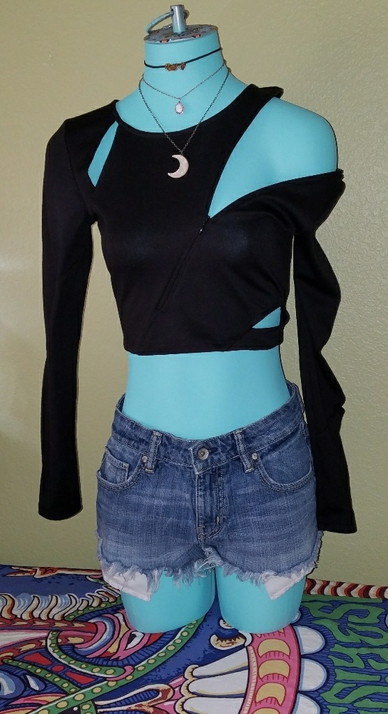 Black crop top with adjustable zipper detailing.